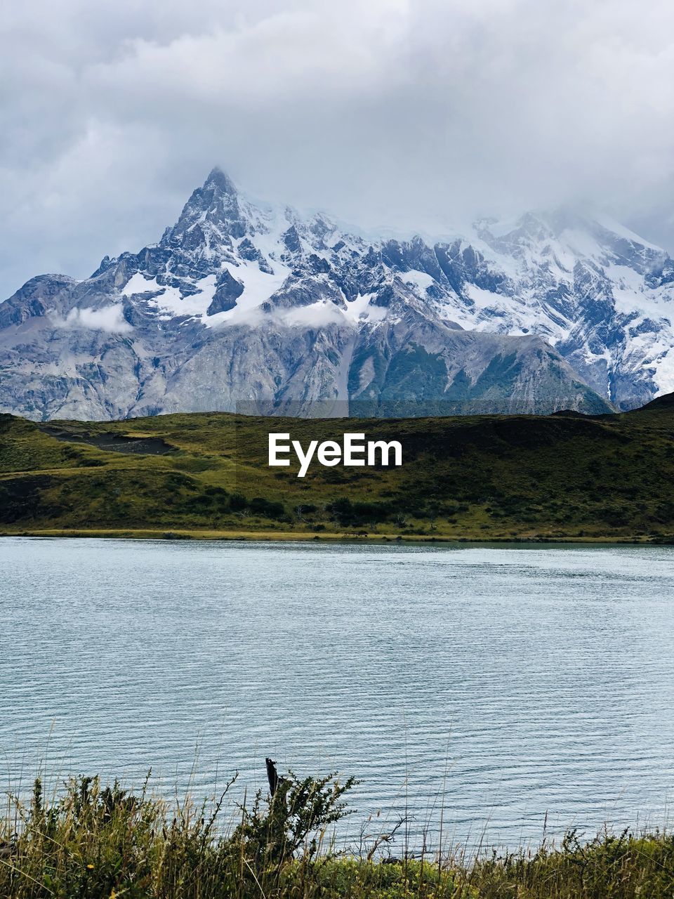 Scenic view of lake and snowcapped mountains against sky