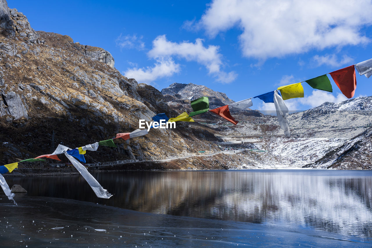 Traditional flags over the lake against sky