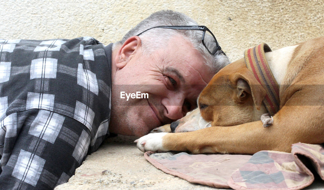 Close-up of man with sleeping dog