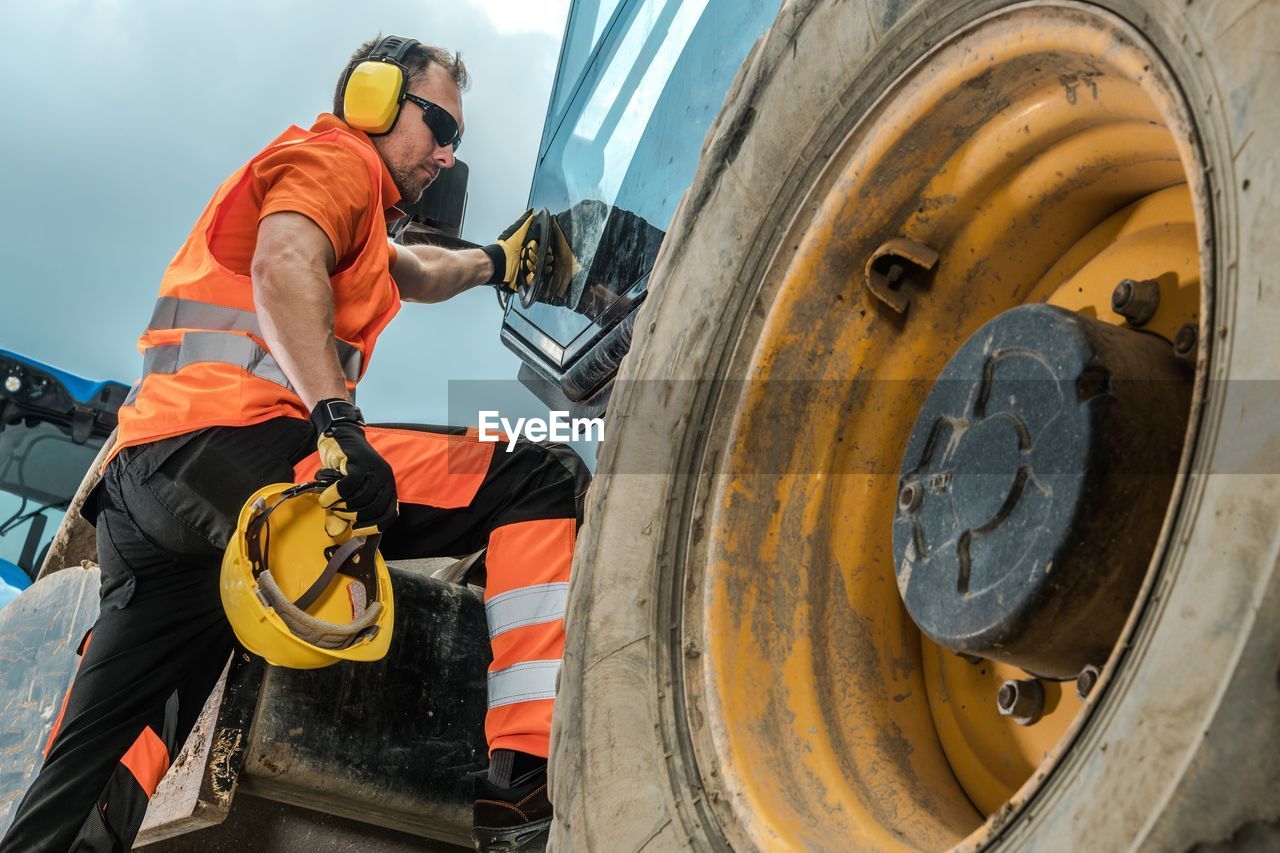 Man standing on construction vehicle