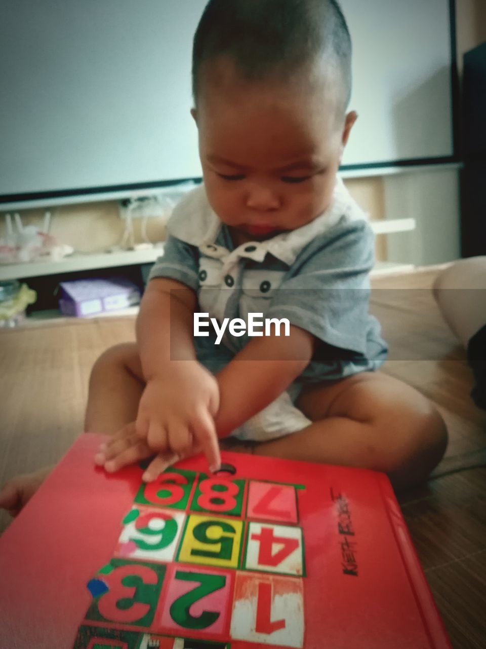 BOY PLAYING WITH BABY AT HOME