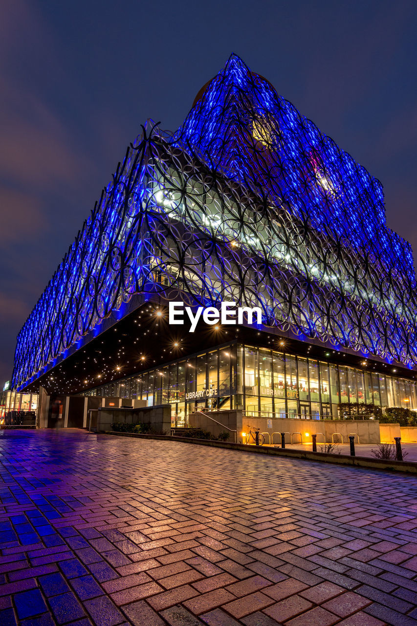 ILLUMINATED BUILDINGS AGAINST BLUE SKY AT NIGHT