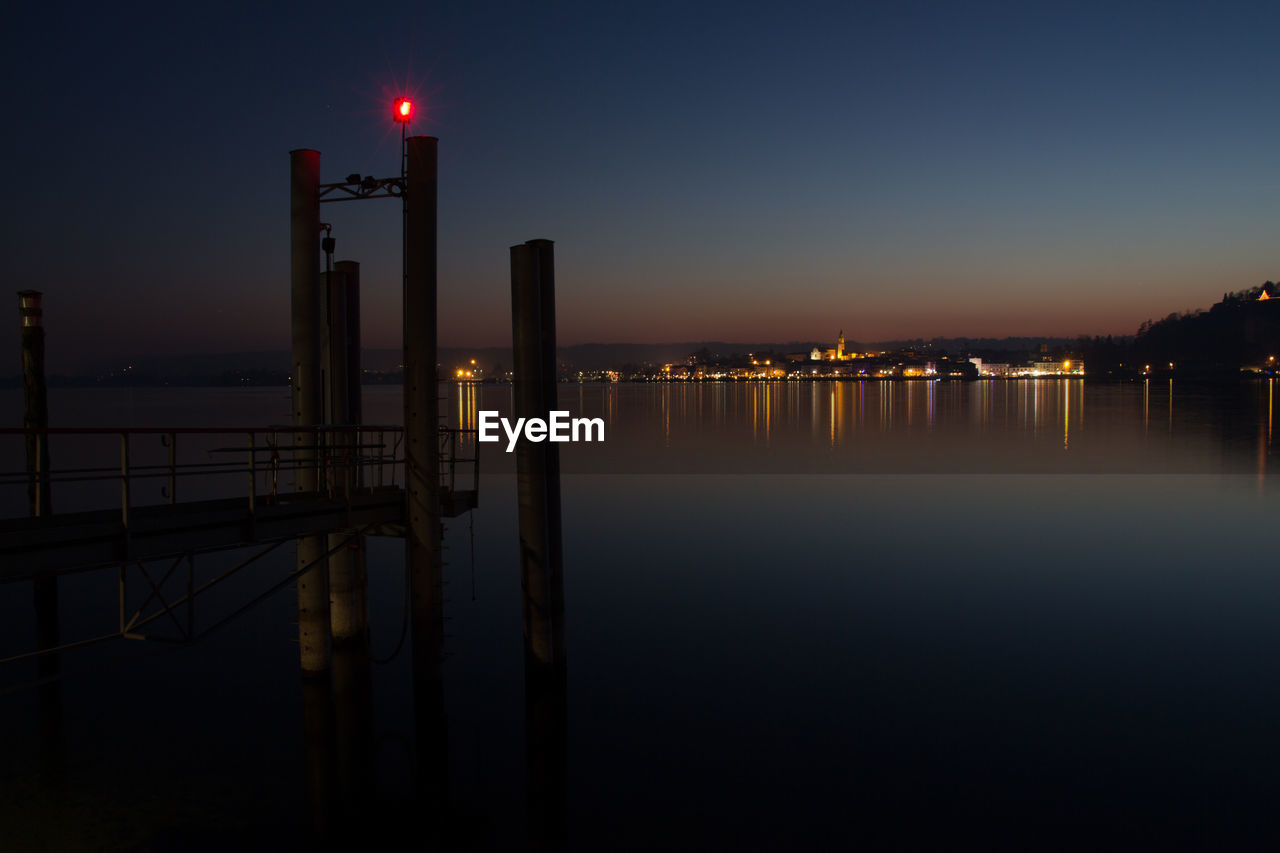 View of illuminated pier at night