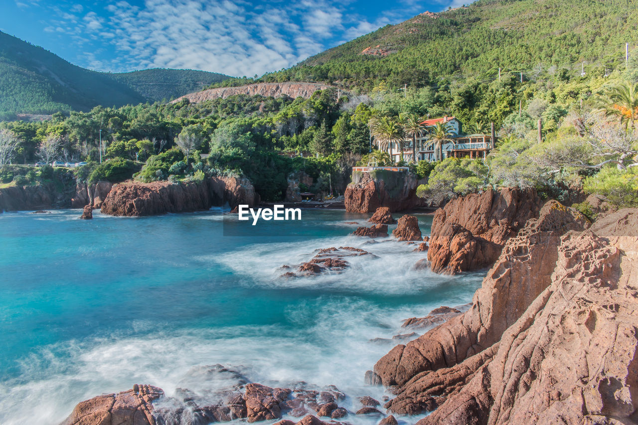 Scenic view of sea and mountains against sky