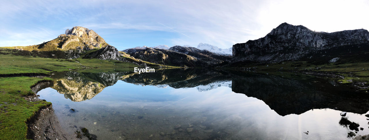 Scenic view of lake and mountains against sky