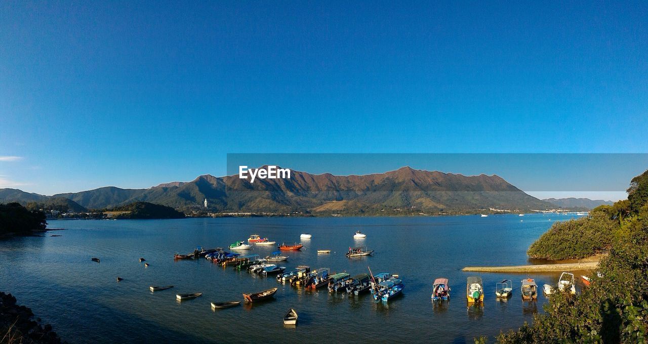 Scenic view of lake against clear blue sky