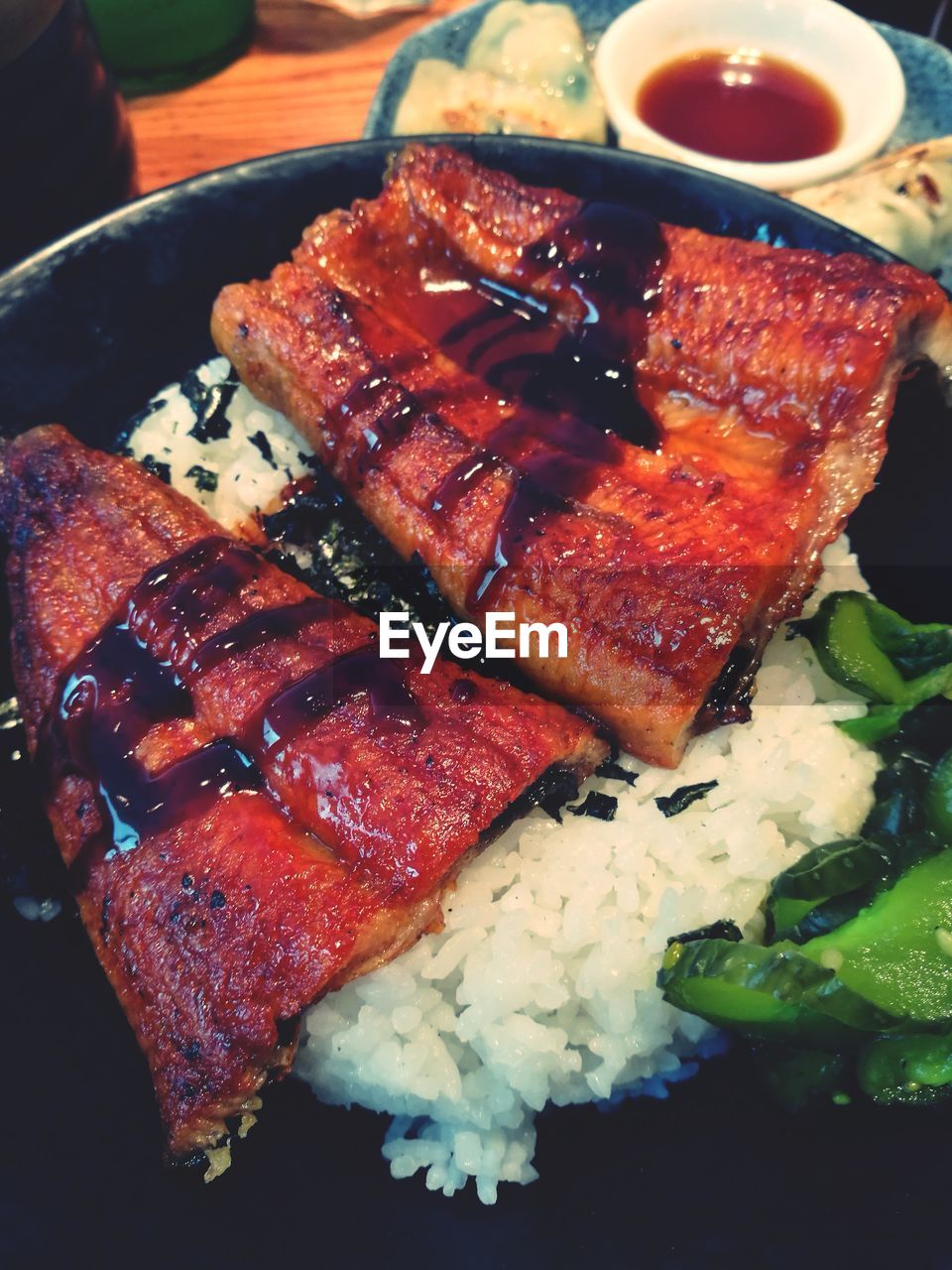 Japanese meal of grilled unagi eel on a bed of rice with soy sauce