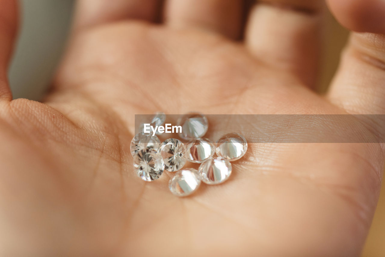 Close-up of hand holding diamonds