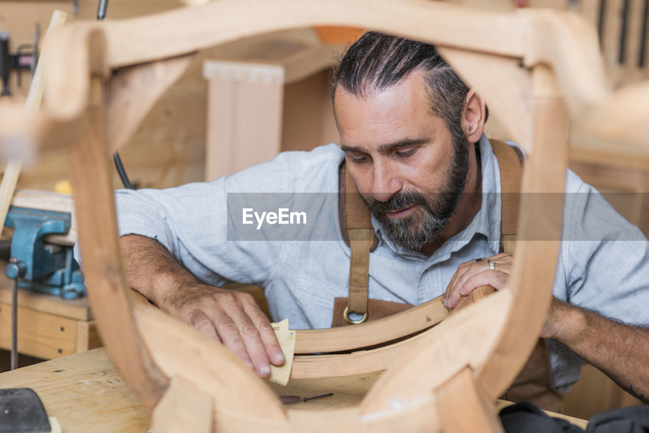 Carpenter making chair in workshop