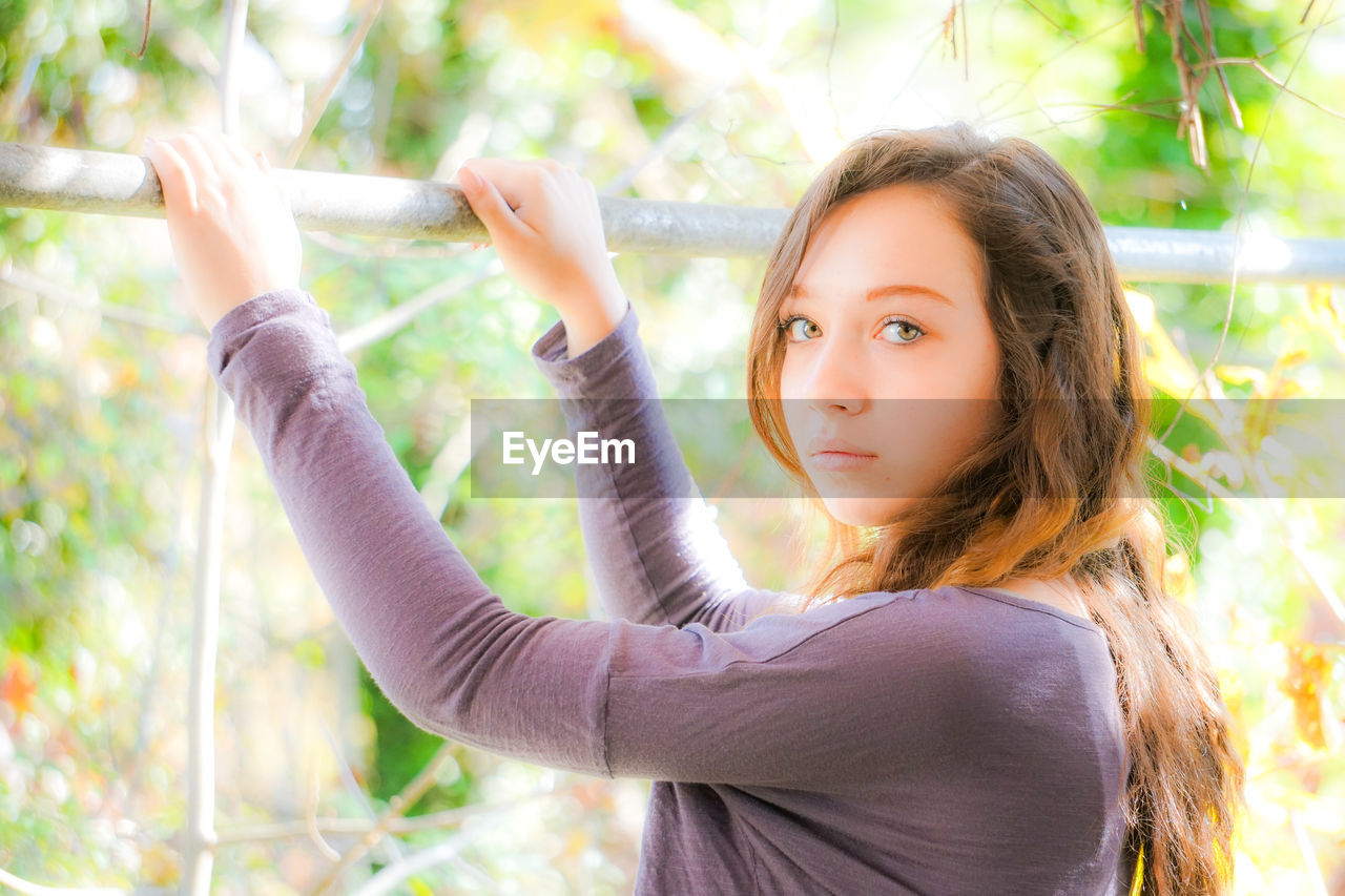 Portrait of confident teenage girl standing outdoors