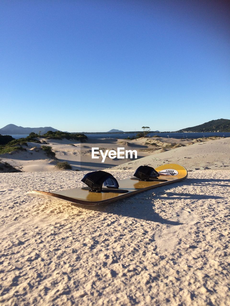 SURFACE LEVEL OF SAND ON BEACH AGAINST CLEAR SKY