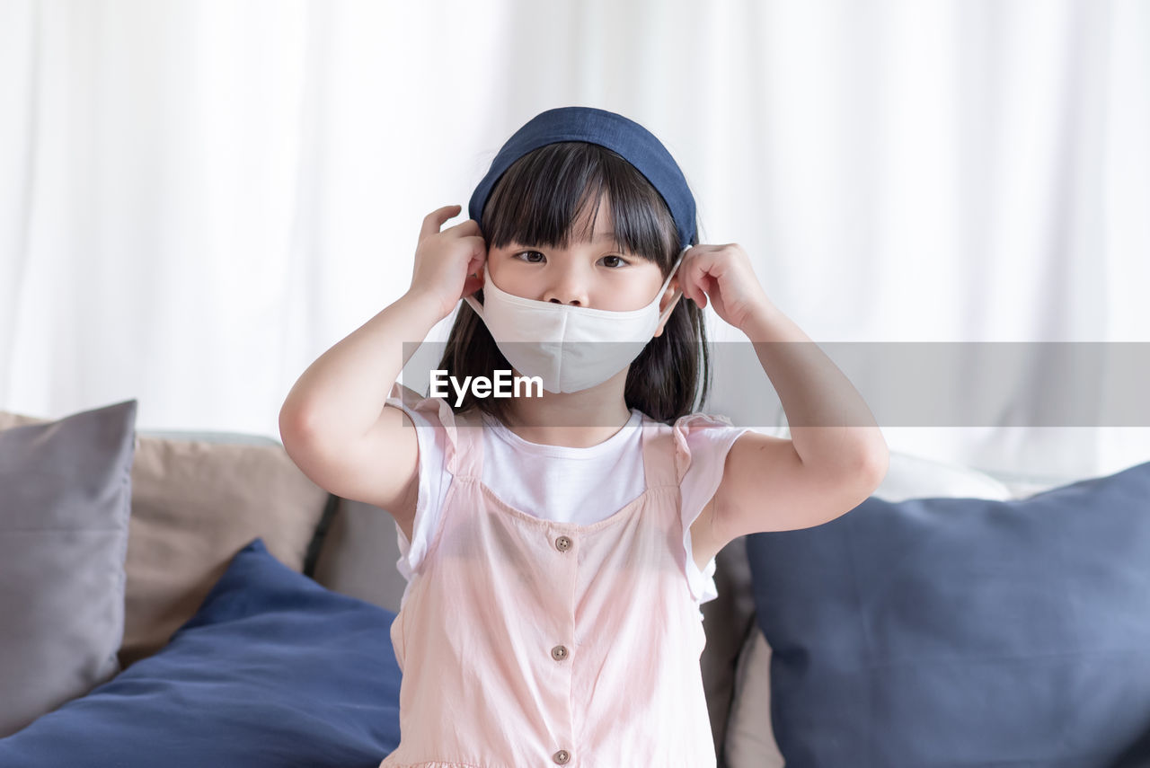 Asian cute girl wearing hygienic face mask for prevent coronavirus or covid19