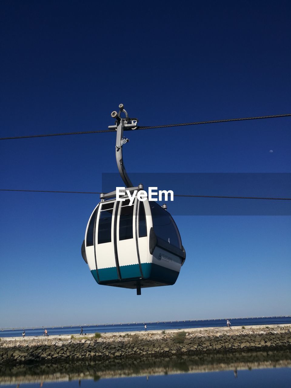 LOW ANGLE VIEW OF CLOTHES HANGING AGAINST CLEAR BLUE SKY AND