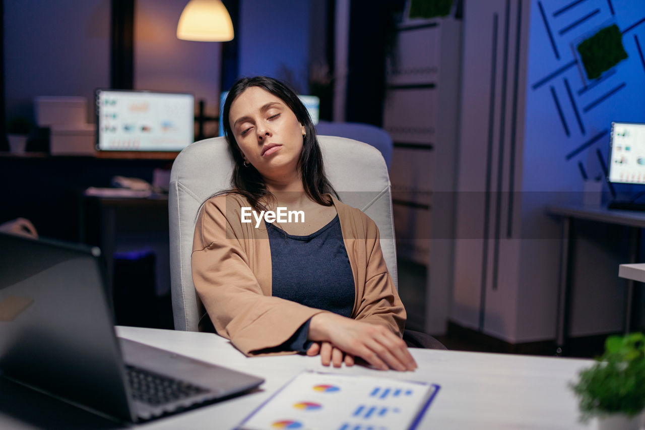 Overworked businesswoman resting at office