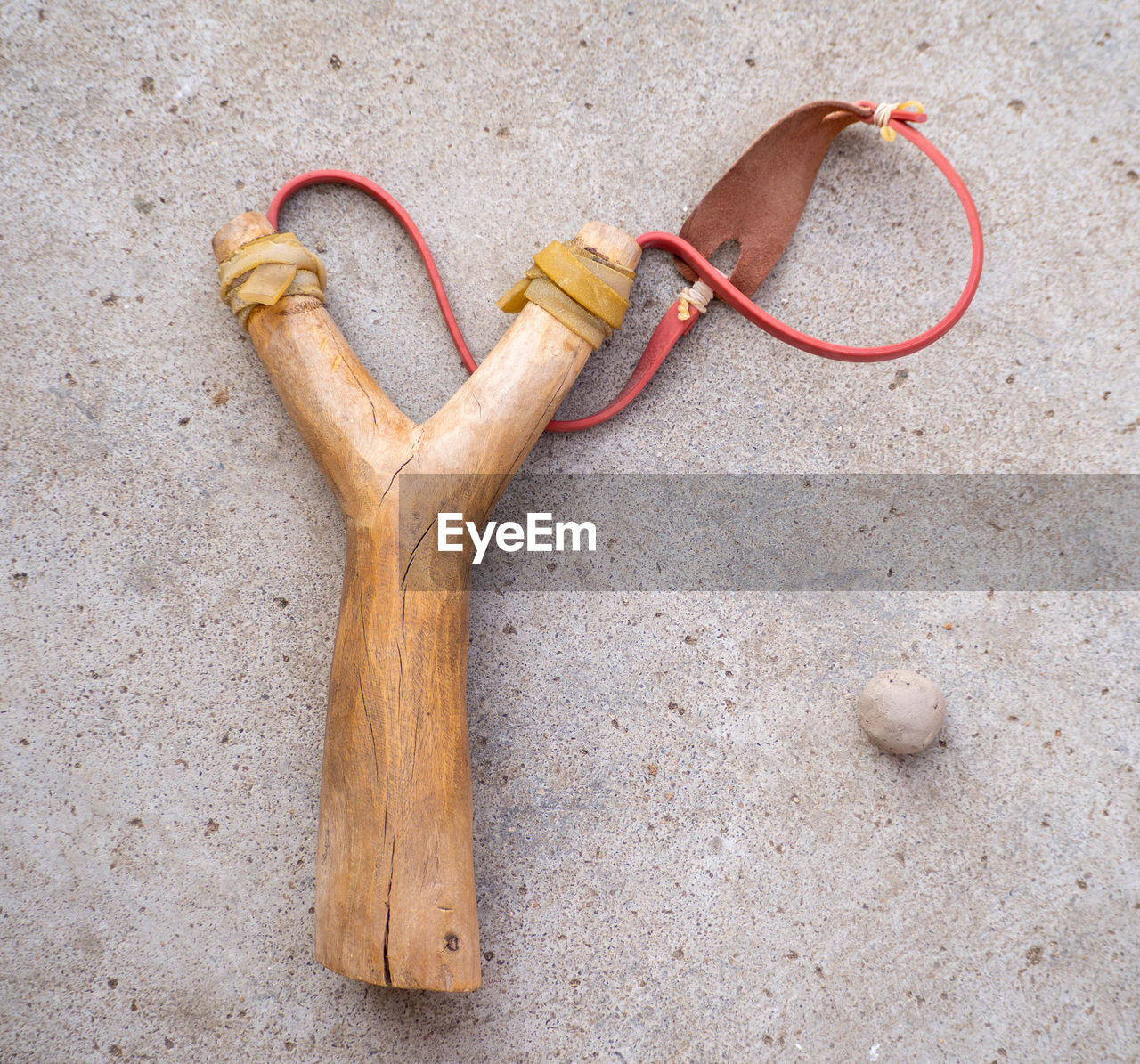 A catapult made of wood and a ball of clay.