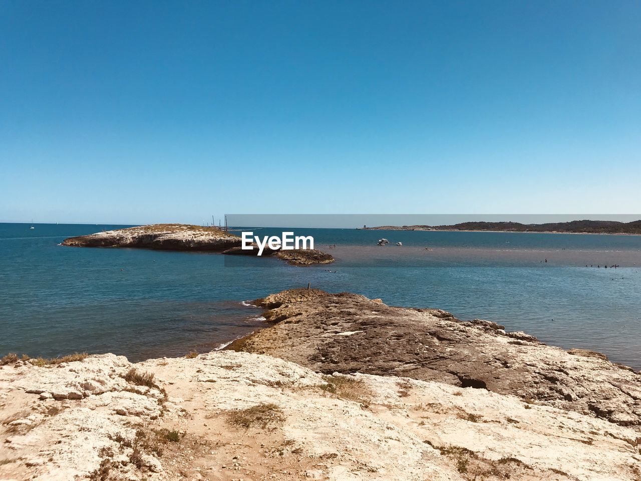 SCENIC VIEW OF BEACH AGAINST CLEAR BLUE SKY