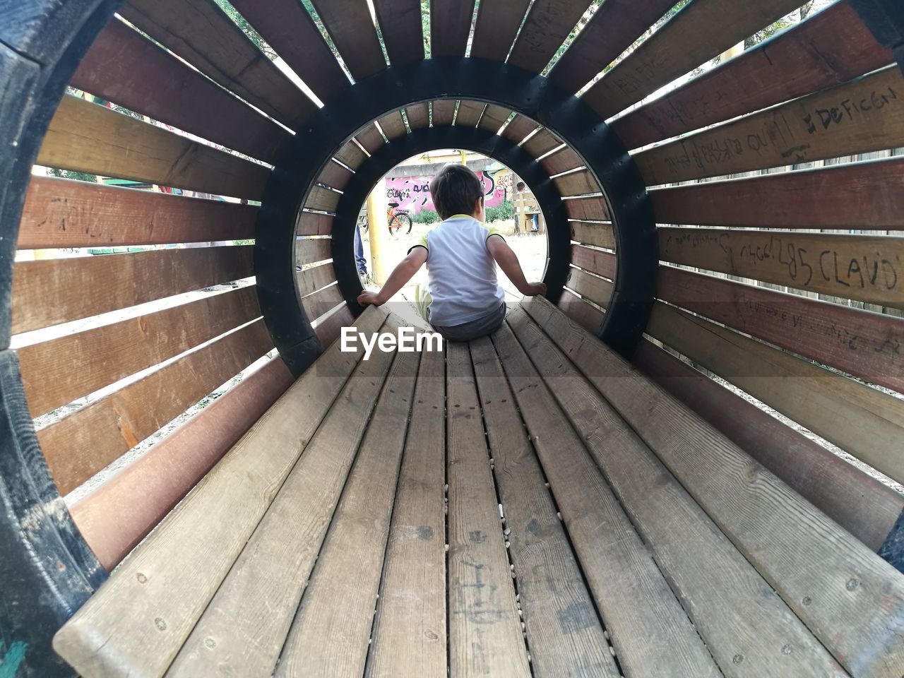 Rear view of sitting in play equipment