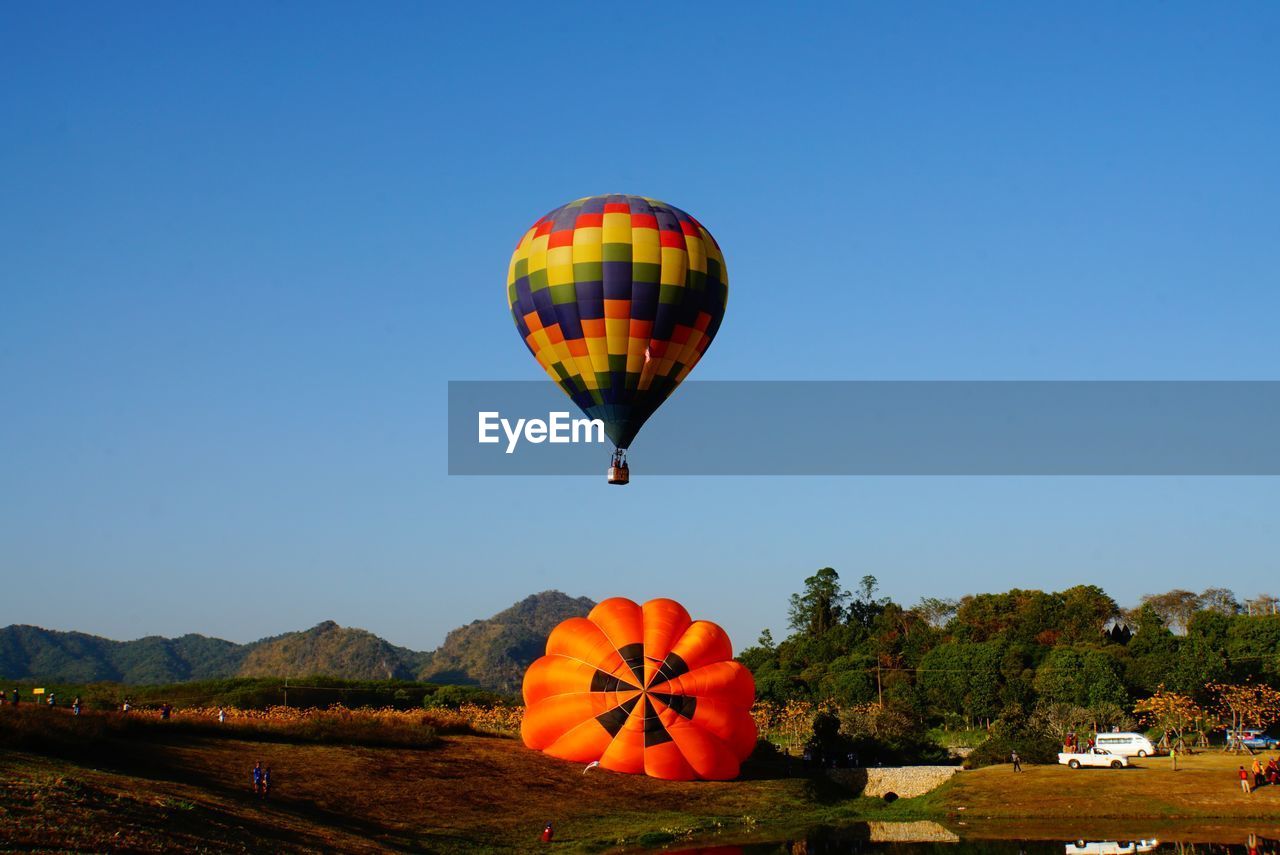 HOT AIR BALLOONS FLYING AGAINST SKY