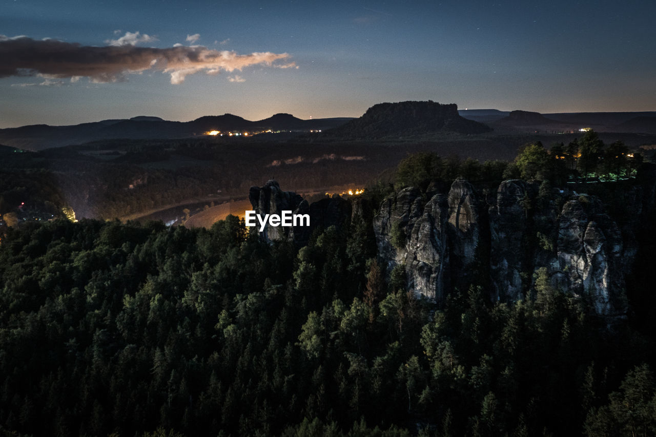 Scenic view of landscape against sky at night