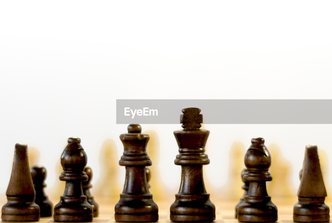 Close-up of chess pieces against white background