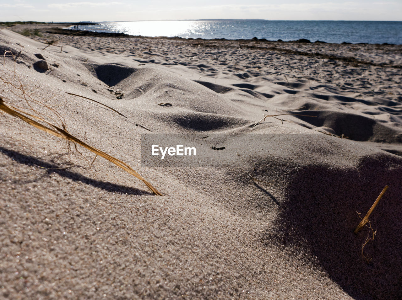 FOOTPRINTS ON SAND AT BEACH