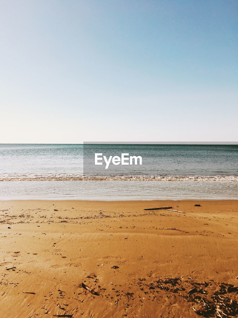 Scenic view of beach against clear sky