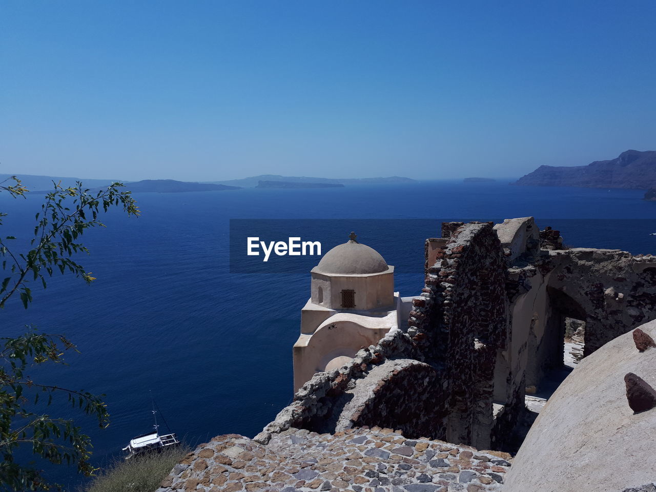 Panoramic view of sea and buildings against clear blue sky