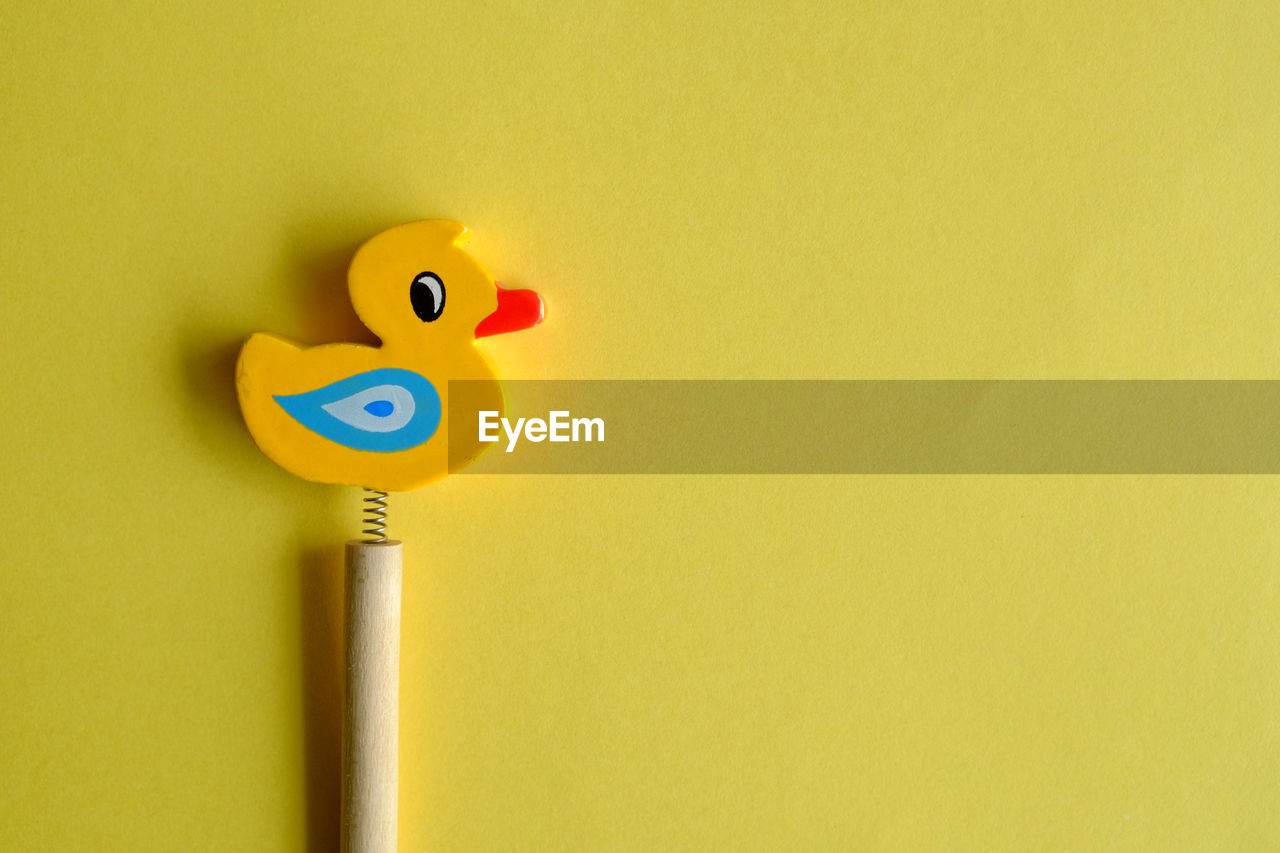 Close-up of toy over yellow background