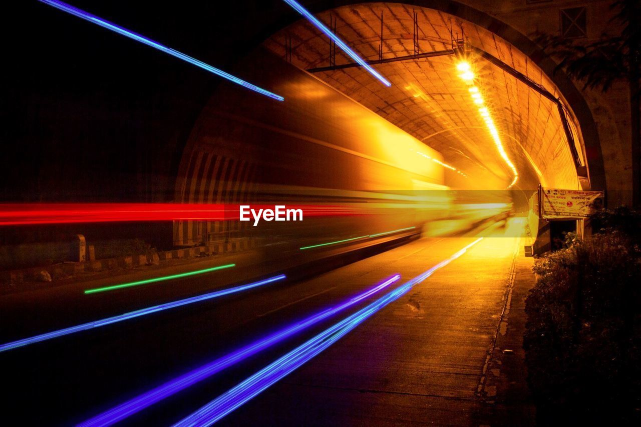 Colorful light trails in tunnel at night