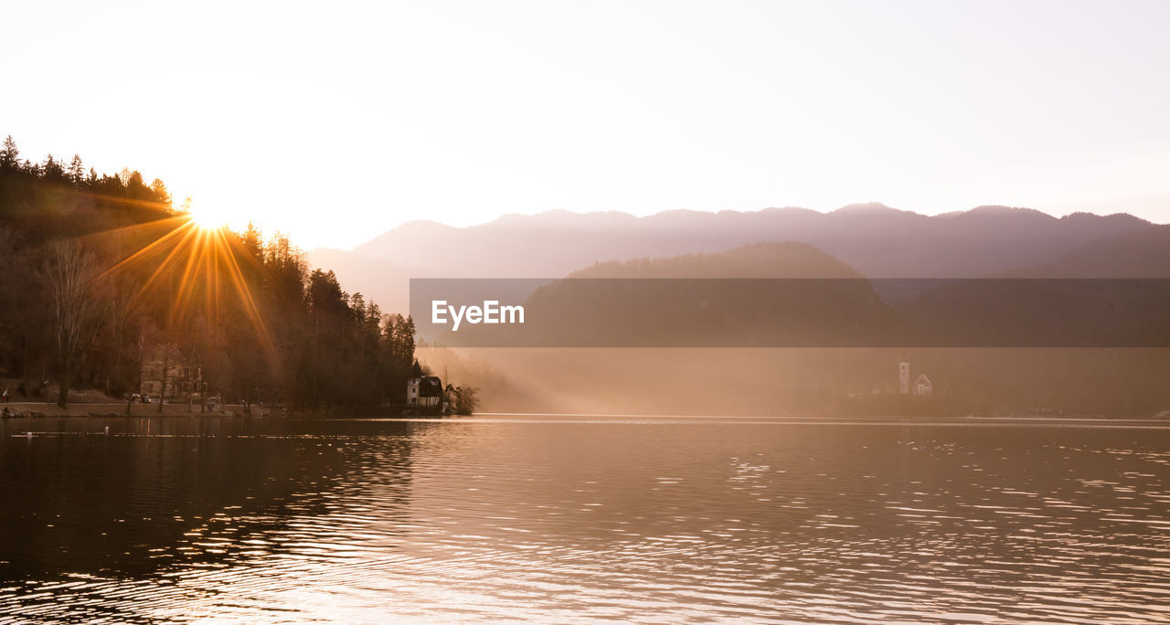 Scenic view of lake against sky during sunset