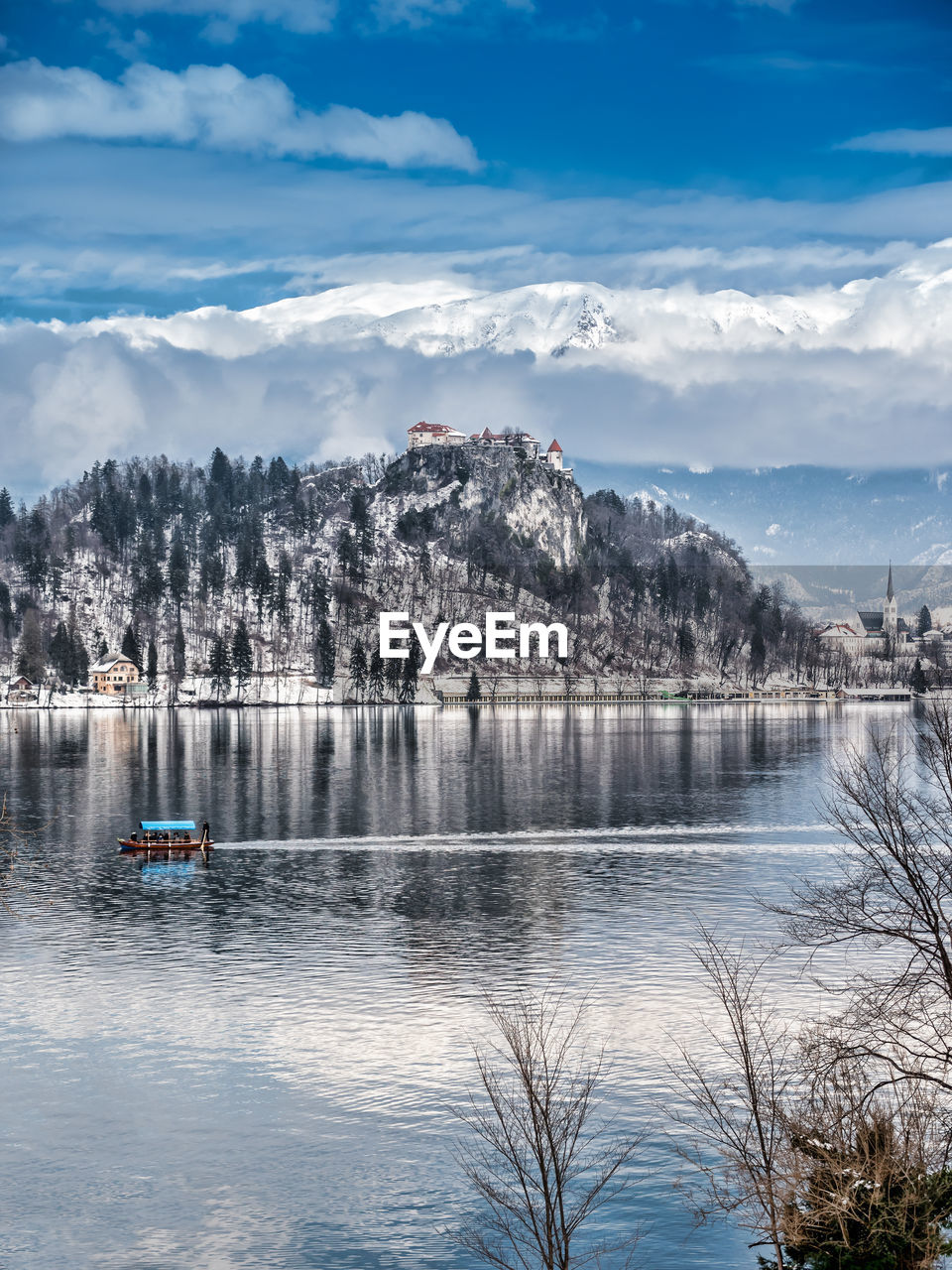 Scenic view of lake and mountain against cloudy sky