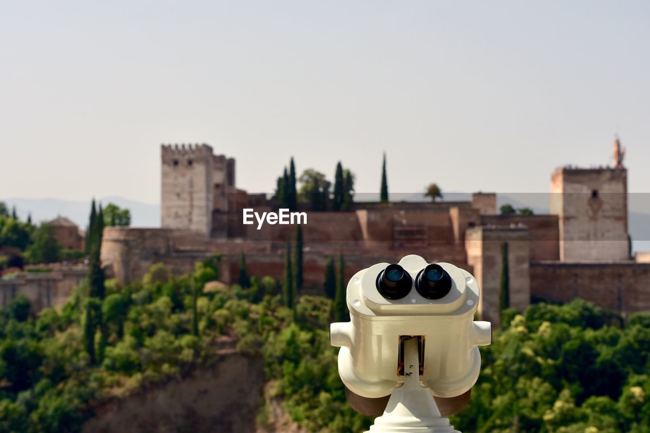 Coin-operated binoculars against historic building