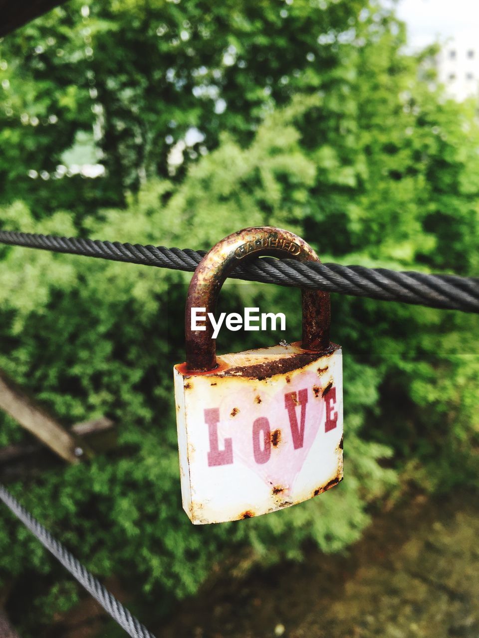 Close-up of love padlock hanging on rope