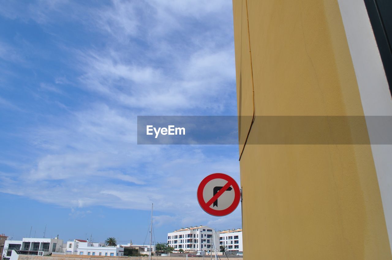 Low angle view of road sign against sky