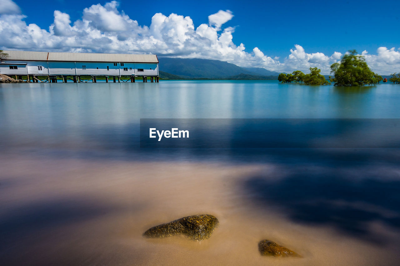 Scenic view of lake against cloudy sky