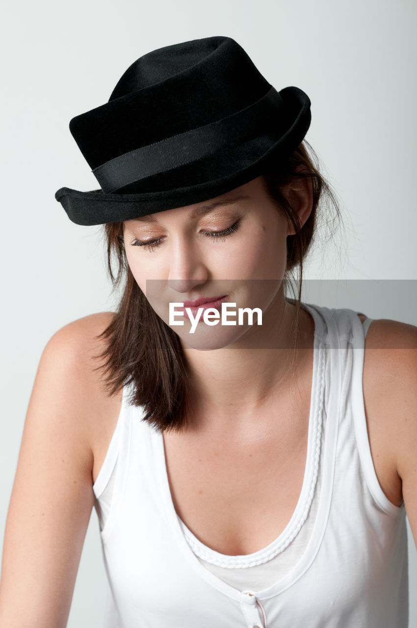 Young woman portrait with black hat looking down