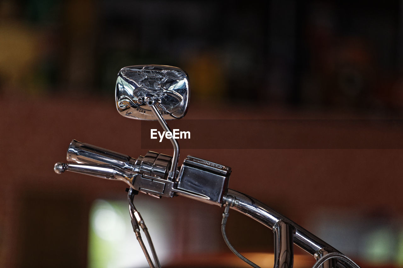 CLOSE-UP OF BICYCLE ON TABLE AGAINST WALL