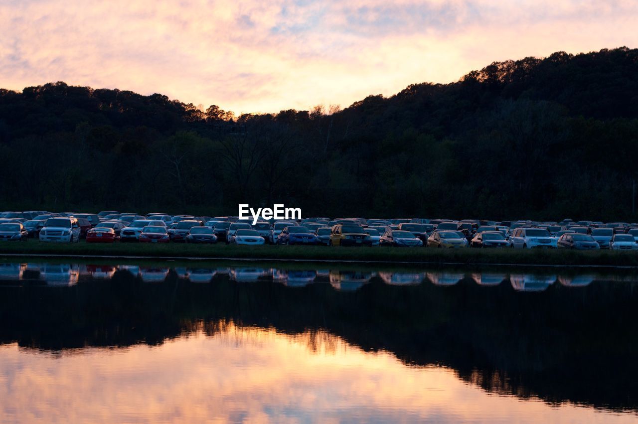 Scenic view of lake against sky at sunset