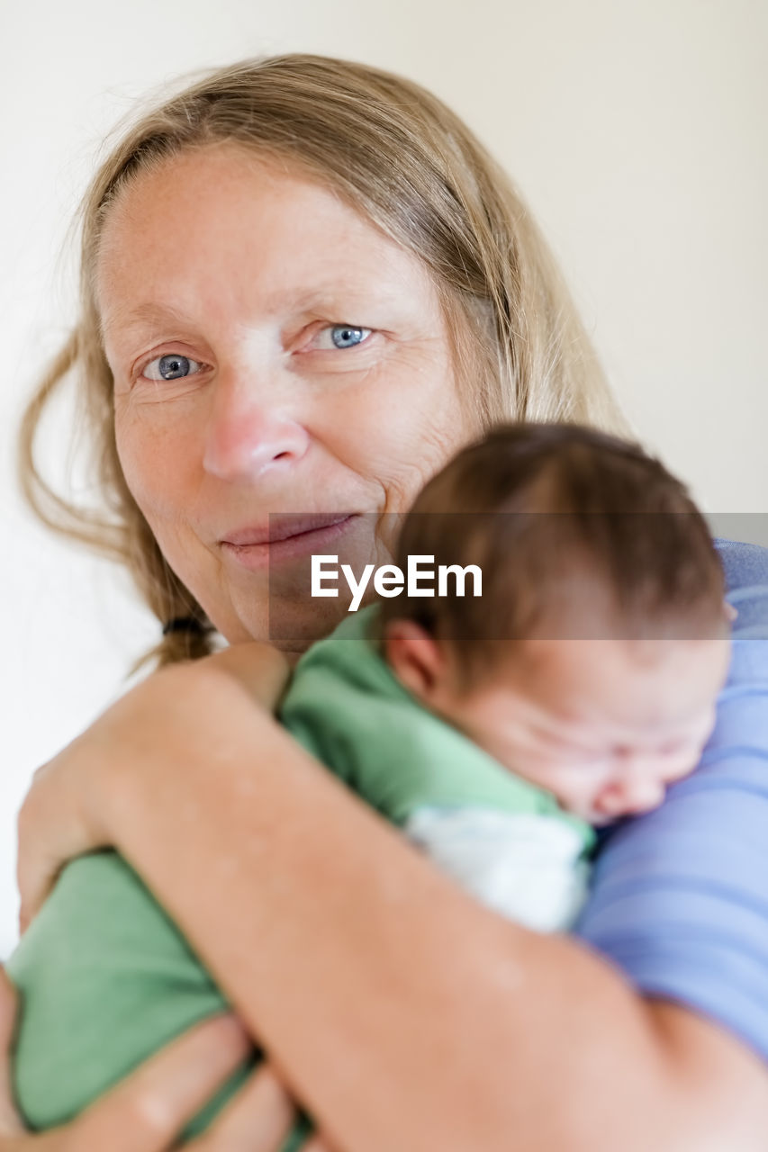 Portrait of mature woman holding grandson