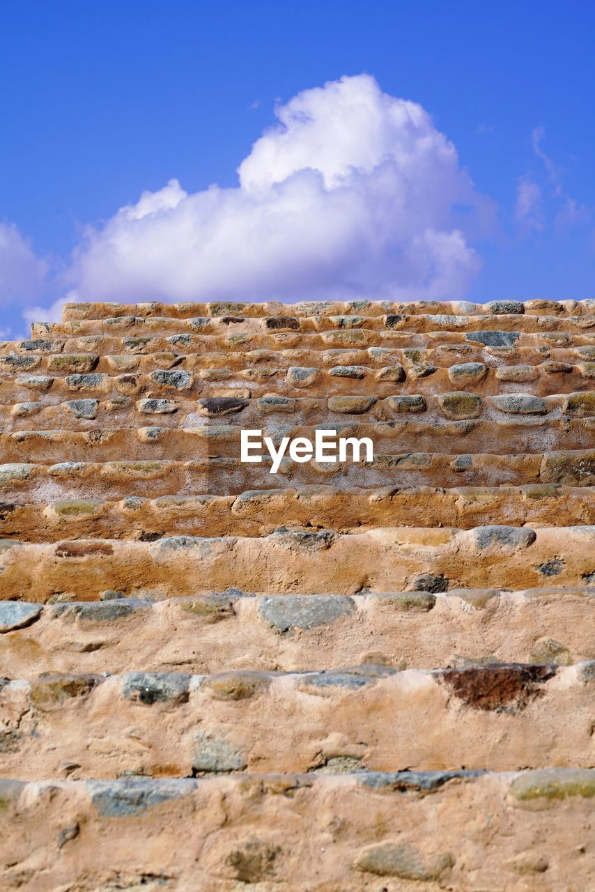 LOW ANGLE VIEW OF BRICK WALL AGAINST SKY