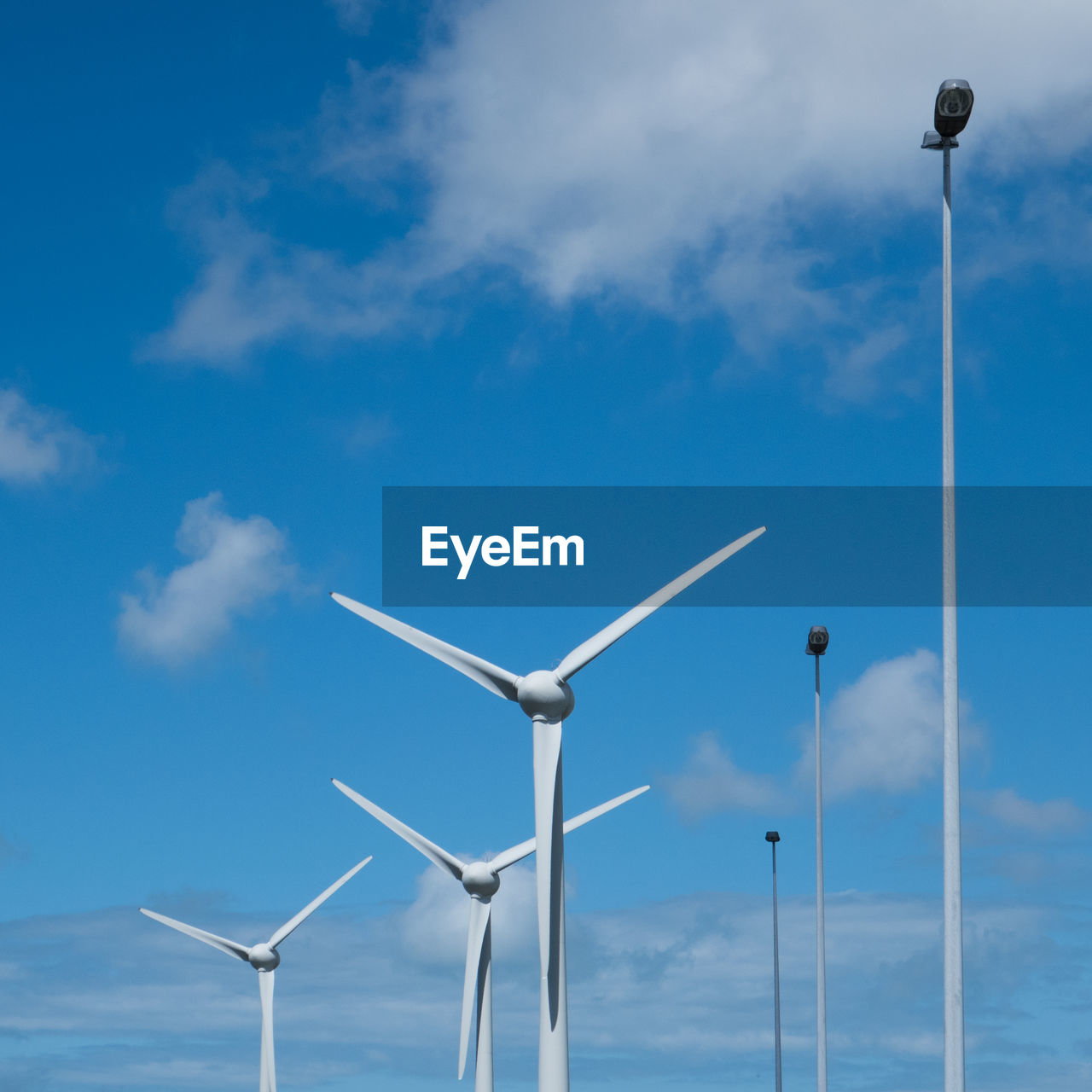 LOW ANGLE VIEW OF WINDMILLS AGAINST SKY