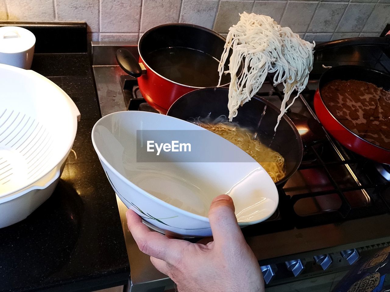 HIGH ANGLE VIEW OF PERSON PREPARING FOOD ON KITCHEN