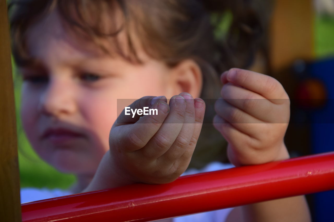 Close-up of cute girl playing on playground