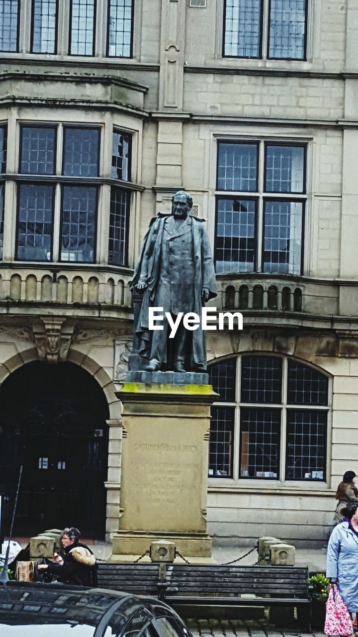 STATUE AGAINST BUILDING