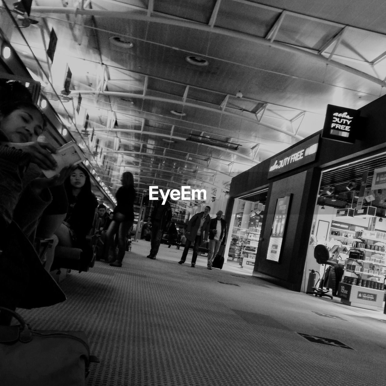 PEOPLE STANDING IN SHOPPING MALL