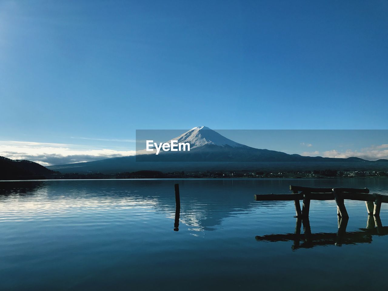 Scenic view of snowcapped mountains against clear blue sky