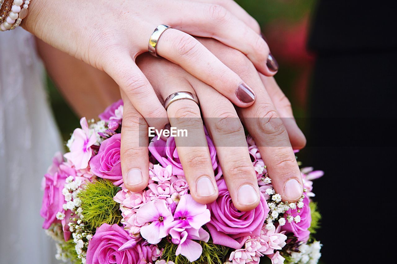 Cropped image of hands holding bouquet