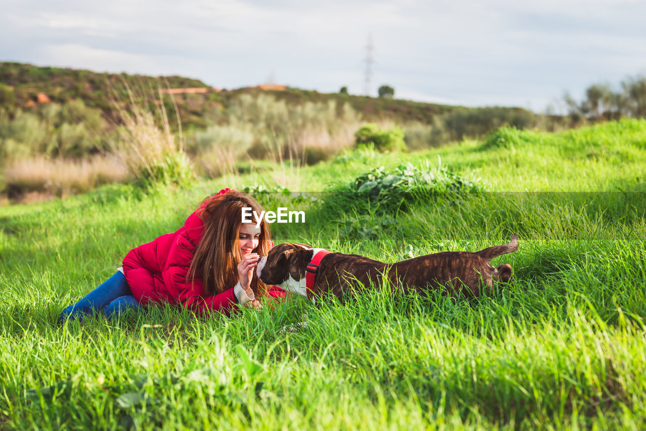 Woman with dog on field