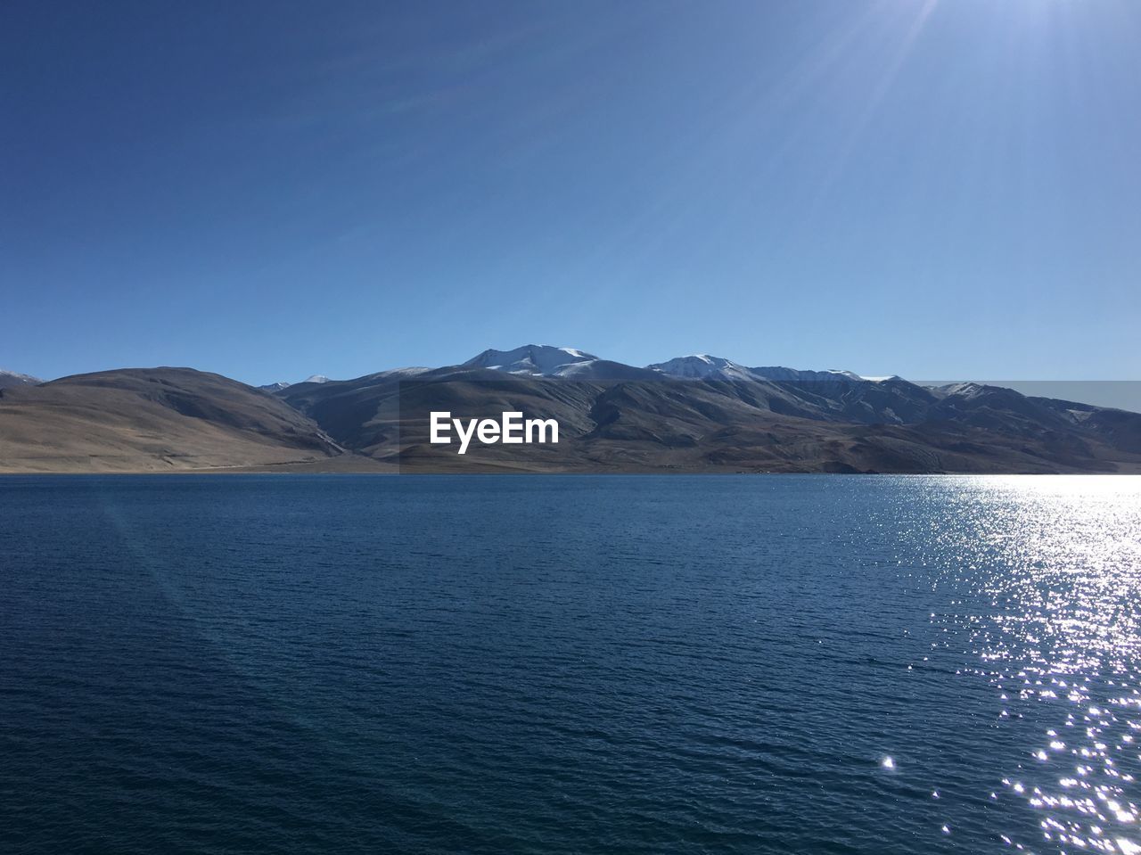 Scenic view of mountains against clear blue sky