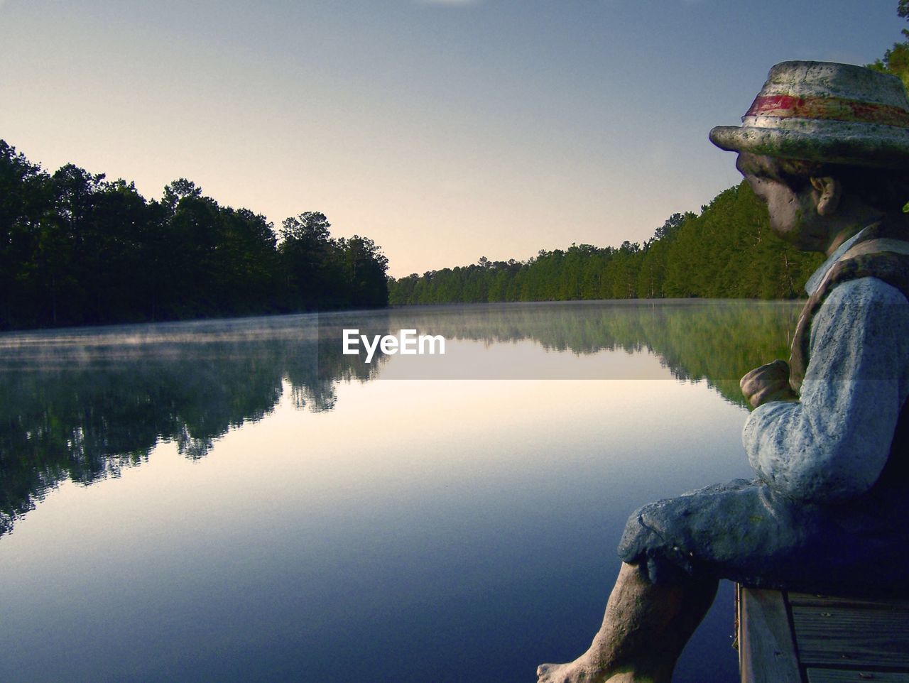 SCENIC VIEW OF CALM LAKE AGAINST SKY